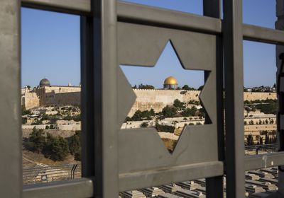 (Oded Balilty | AP)The Islamic Dome of the Rock in Jerusalem's Old City is seen trough a door decorated with a Jewish Star of David in 2017. Columnist Jeffrey Salkin explains how Jewish adherents believe life goes on after death.