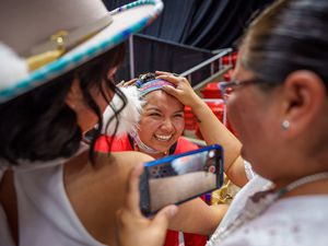 (Trent Nelson  |  The Salt Lake Tribune) Kayden Denny with her sister Jace and mother Tanya after performing a Native American hoop dance at Highland High School's graduation in Salt Lake City on Friday, June 9, 2023.